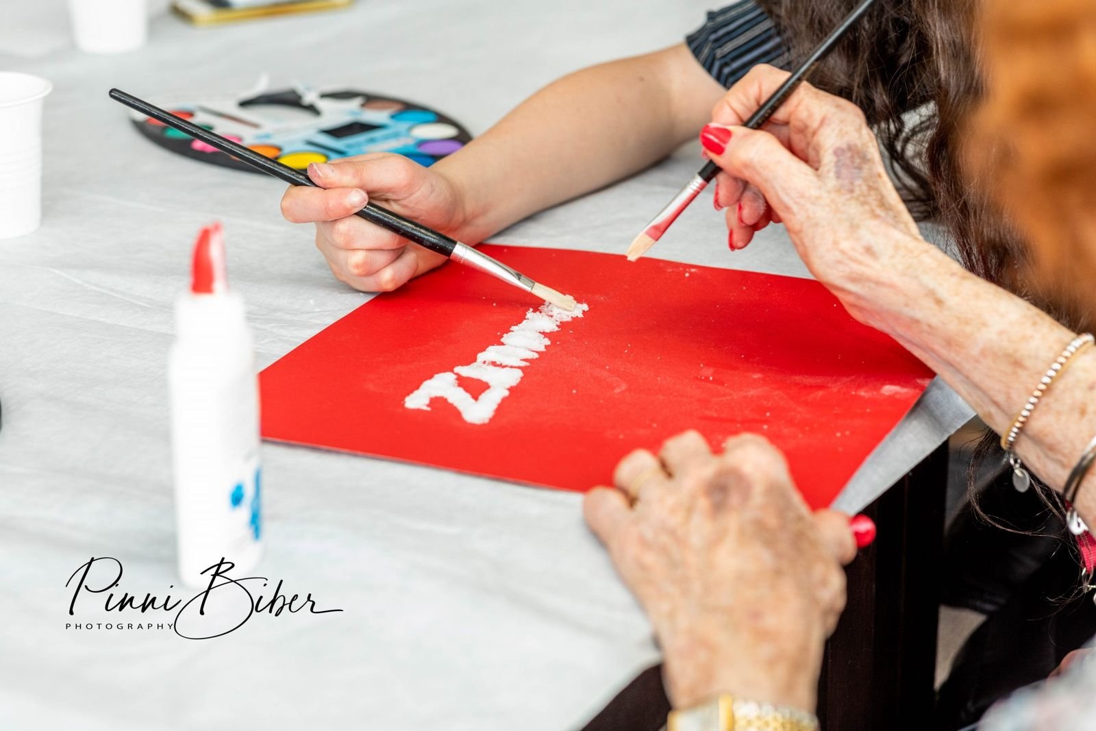 Hands drawing a card for a Shabbat package