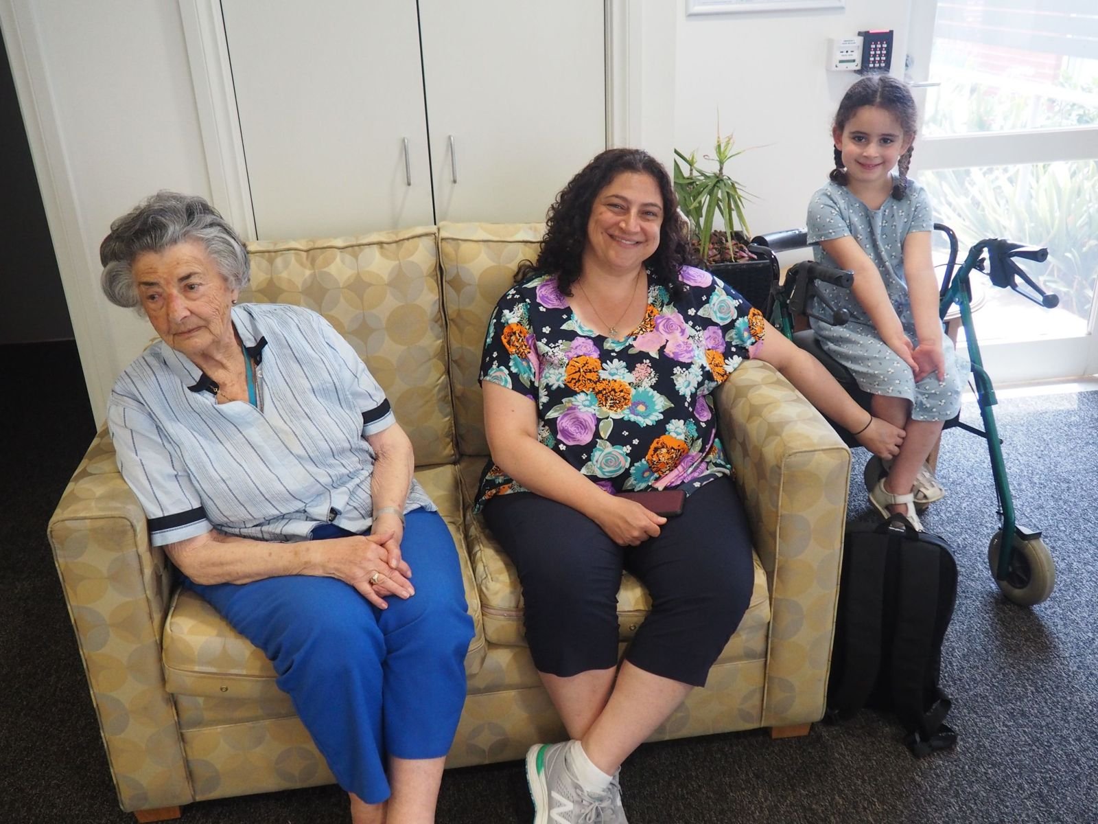 A visitor and her daughter spending time with a senior resident